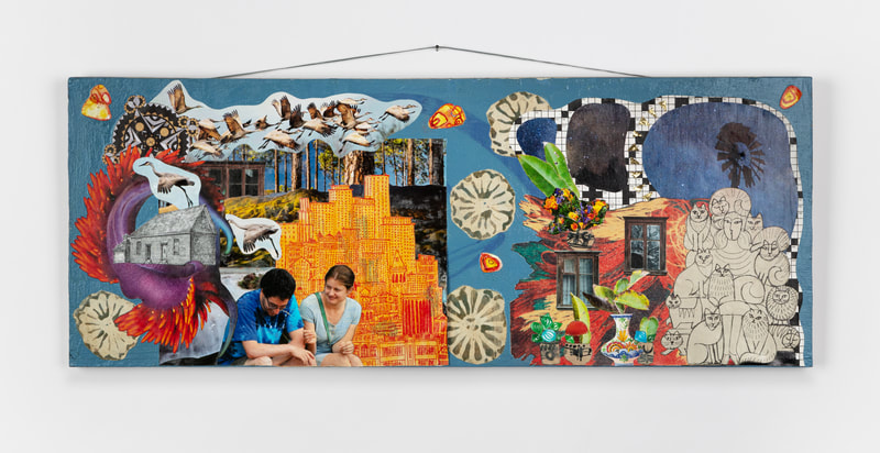 A colorful and surreal collage on a long, horizontal board, hanging from a nail in the wall. The collage includes images of a couple, cranes, a house, a cityscape, flowers in vases, windows, a windmill against the night sky, and a woman surrounded by cats.